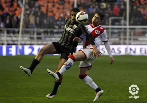 Rayo Vallecano players celebrate crisp win at Valencia's Mestalla stadium under floodlights
