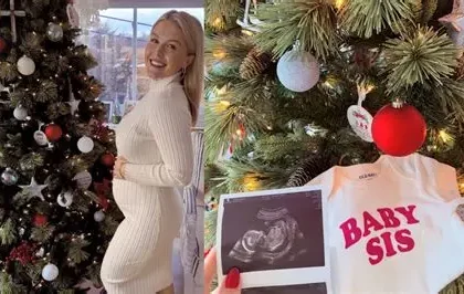 Karoline Leavitt holding her newborn daughter while smiling in a family photo shared online.