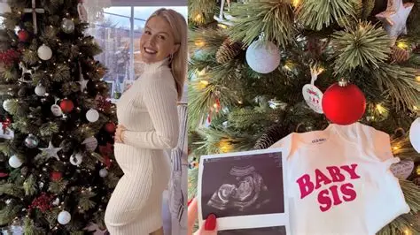 Karoline Leavitt holding her newborn daughter while smiling in a family photo shared online.