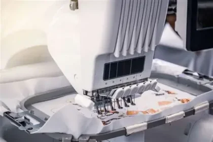 Garment manufacturing robot applying adhesive to fabric seams to automate clothing production in 2026