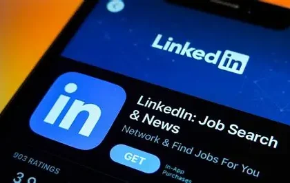 LinkedIn office building with employees discussing workforce restructuring and layoffs