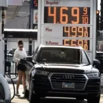Driver filling a car with fuel as U.S. gas prices surge across the country.