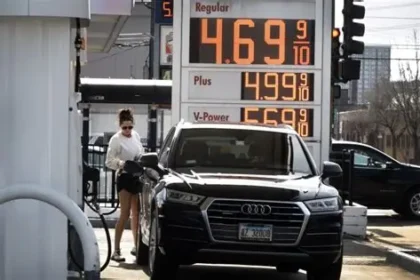 Driver filling a car with fuel as U.S. gas prices surge across the country.
