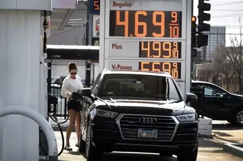 Driver filling a car with fuel as U.S. gas prices surge across the country.