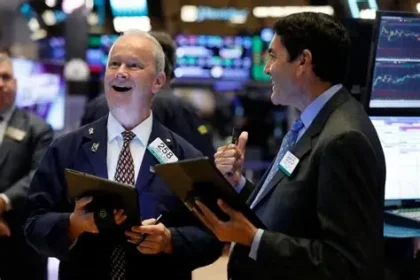 Traders monitor stock market screens as the S&P 500 reaches a record high on Wall Street.
