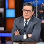 Stephen Colbert speaking during a late-night television interview while discussing the future of his show and CBS programming changes.