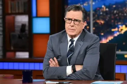 Stephen Colbert speaking during a late-night television interview while discussing the future of his show and CBS programming changes.
