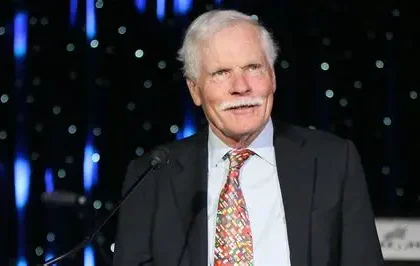 Ted Turner standing inside a CNN newsroom during the early years of the network