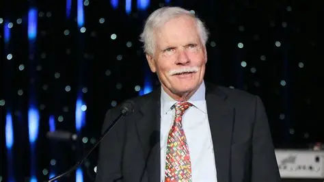 Ted Turner standing inside a CNN newsroom during the early years of the network
