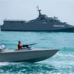 U.S. naval forces patrol near oil tankers in the Strait of Hormuz during heightened tensions with Iran.