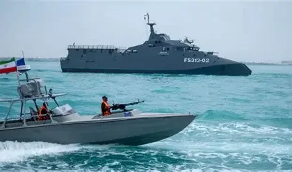 U.S. naval forces patrol near oil tankers in the Strait of Hormuz during heightened tensions with Iran.