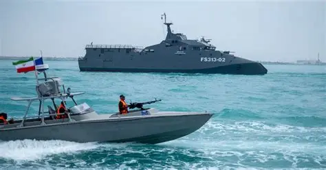 U.S. naval forces patrol near oil tankers in the Strait of Hormuz during heightened tensions with Iran.