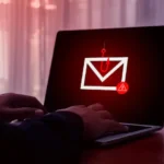 Phishing scams warning signs displayed on a laptop and smartphone screen