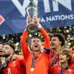 Cristiano Ronaldo celebrating with trophies won during his legendary football career