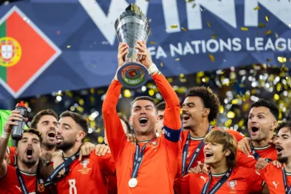 Cristiano Ronaldo celebrating with trophies won during his legendary football career