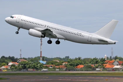 Airplanes painted white at an airport showing sunlight reflection airline liveries maintenance and aircraft leasing