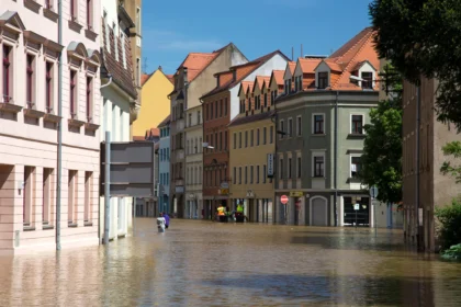 Localized flooding showing one city underwater while a nearby city remains dry